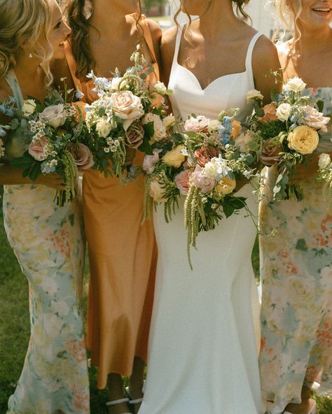 I hope colorful wedding days are here to stay 😌 especially the whimsy florals & mix and match bridesmaid dresses 🧡 #iowaweddingphotographer #desmoinesweddingphotographer #desmoineswedding #weddingcolorscheme #colorfulwedding #iowaphotographer Peach And Sage Bridesmaid Dresses, Mix Match Floral Bridesmaid Dresses, Spring Floral Bridesmaid Dresses, Mix Match Bridesmaid Dresses Spring, Mix Match Bridesmaid Dresses Fall, Fall Floral Bridesmaid Dresses, Boho Bridesmaid Dress Mismatched, Wild Flower Bridesmaid Dresses, Color Palette Bridesmaid Dresses