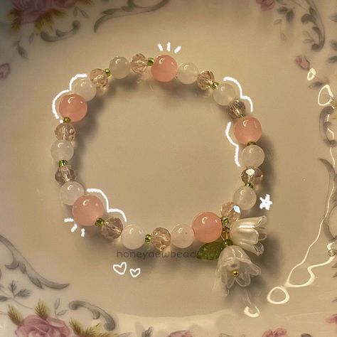 my lily of the valley bracelet 🪷 . . . . . . . . . . . #explore #explorepage #jewelry #beadwork #beads #beadsoup #charms #bracelets #etsy #etsyfinds #beadjewelry #beadbracelets #coquette #coquetteaesthetic #coquettefashion #coquettegirl #pastelaesthetic #lilyofthevalley #beadsbracelet #flowers Cheap Pink Pearl Wedding Bracelet, Cheap Pink Charm Bracelet With Faceted Beads, Cheap Pink Bracelets For Best Friend Gift, Cheap White Kawaii Beaded Bracelets, Cheap Pink Sentimental Beaded Bracelets, Cute Cheap Pink Bracelet, Cheap Romantic Pink Beaded Bracelets, Cheap Romantic Beaded Bracelets, Cheap Pink Romantic Beaded Bracelets