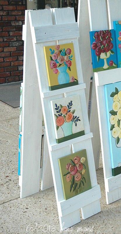 shutter easel lana manis Plywood Display Wall, Vertical Display Ideas, Displaying Coasters For Sale, Creative Ways To Display Artwork, Outdoor Display Exhibition, Backyard Boutique Ideas, How To Display Vinyl Decals To Sell, Car Charm Vendor Display, Diy Trade Show Display