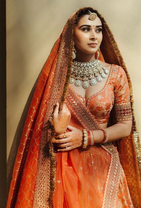 Photo of unique bridal jewellery with an orange lehenga Orange Pink Bridal Lehenga, Orange Red Bridal Lengha, Unique Bridal Looks Indian, Orange Wedding Lehenga Indian Bridal, Indian Bridal Photos Wedding Dresses, Indian Bridal Lehenga Pastel, Rust Wedding Lehenga, Rustic Orange Bridal Lehenga, Burnt Orange Bridal Lehenga