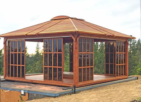 Sun Gazebo (Options: 16' L, 16' W, Redwood, 4' x 4' Skylight, No Flooring, Transparent Premium Sealant). Photo shows only 8 doors/panels, the rest were installed after the photo was taken. Photo Courtesy of L. Moresco of San Francisco, CA. Pavillion Backyard, Gazebo Bar, Outdoor Pavillion, Enclosed Gazebo, Deck Inspiration, Gazebo Lighting, Gazebo Decorations, Gazebo On Deck, Large Gazebo