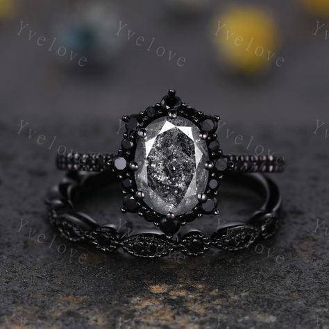 Gothic Oval Shape Salt and Pepper Diamond Engagement Ring Set,Black Gold Diamond Promise Ring Unique Rhodium Black Witchy Ring Bridal Gift,Anniversary Ring Gift For Her,moissanite band ,antique ring set for women Material: Solid gold (10k 14k 18k rose gold,yellow gold,white gold,Platinum available) Main stone:6x8mm oval Cut natural Salt and Pepper Diamond(Every stone will be unique and vary!) Side stone:with black spinel halo and wedding band  0.25ct round cut real diamonds Band width:approx 1.8 Gothic Wedding Rings His And Hers, Rose Gold Black Diamond Ring Engagement, All Black Engagement Ring, Black Silver Engagement Ring, Black Rings For Women Engagement, Rose Gold And Black Engagement Ring, Unique Gothic Engagement Rings, Gothic Wedding Rings Set, Dark Engagement Ring Black Diamond