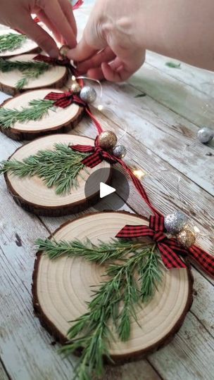 DIY Christmas Wood Slice Garland | Here's the video for the wood slice Christmas garland using my own dried pressed juniper ✨️🎄I hope y'all enjoy the video!   Also, thank you so much for... | By Love Crafted Decor | Hey y'all here's how I made the Christmas Wood Slice Garland so I'm using real pressed juniper that I got off of my own little juniper bush in my yard I got these wood slices off of Amazon and I'm just gluing the pieces of pressed juniper to the wood slices and then I'm feeding through a little piece of twine to make them into a little hanger and you could honestly use all these same steps to make these into ornaments instead if you don't want to make this into garland and then just add a little color to them I'm using this buffalo check mini bows and y'all I'm still working o Ornaments Using Wood Slices, Wood Chip Wreath, Christmas Wooden Garland, Wood Slice Tree, Christmas Decorations Wood Slices, Buffalo Check Christmas Ornaments Diy, Ornaments Out Of Wood Slices, Diy Wood Slice Ornaments For Kids, Sliced Wood Ornaments Diy