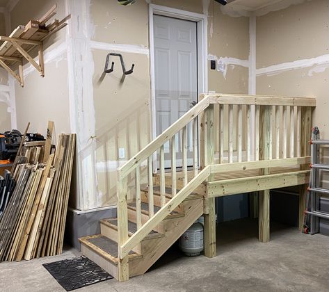 Fashioned using 4x4 treated lumber for posts, 2x and 1x construction lumber for the frame and railing, then deck boards for the platform. Stringers are custom from 2x12’s. Garage Railing Ideas, Garage Stairs With Landing, Garage Stair Storage, Steps Going Into House From Garage, Steps In Garage To House, Garage Platform Entry, Garage Stair Railing, Garage Steps Into House With Landing, Garage Landing Ideas