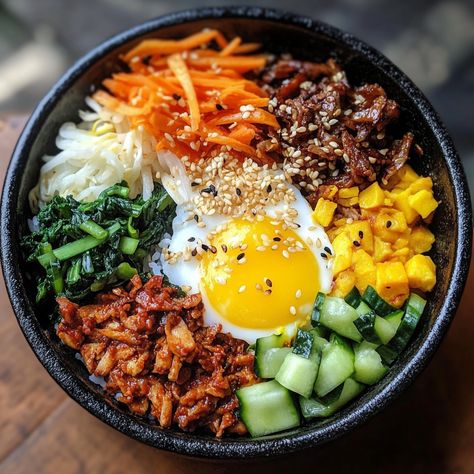 Bibimbap originated from Korean royal cuisine but quickly became a beloved dish for the masses. Traditionally, it was a way to use leftover vegetables and rice, with everything mixed together for a colorful, flavorful meal. Its vibrant presentation symbolizes harmony and balance, two important principles in Korean culture.

#Bibimbap #KoreanFood #HealthyMeals #Gochujang #AsianCuisine #RiceBow Colorful Meals Aesthetic, Korean Mixed Rice, Korean Bipinbop, Bimbimbop Bowl, Bibimbap Aesthetic, Asian Food Healthy, Rice Food Recipes, Chicken Bibimbap, Traditional Korean Food