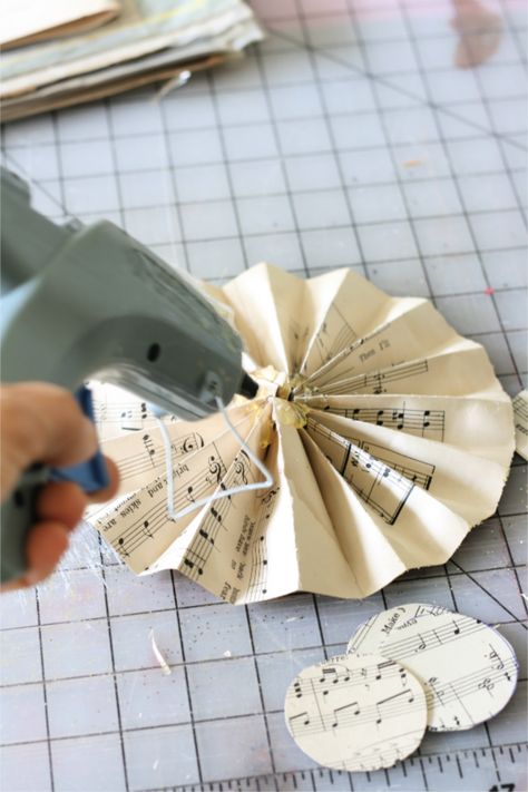 paper craft fan, medallion, rosette, pinwheel Hymnal Christmas Ornaments, Crepe Paper Rosettes Diy, Paper Rosettes Diy How To Make, Sheet Music Crafts Diy, Music Paper Crafts, Folded Book Christmas Tree, Pinwheel Ornaments, Paper Pinwheel Diy, Diy Paper Fan