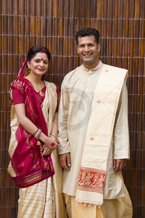 Traditional Bengali Attire - Bengali women traditionally drape the saree without pleats. It is wrapped around the waist and drawn back in a reverse pleat to the right and then back over the left shoulder. The leftover pallu is thrown over the right shoulder traditionally tied to a heavy jewellery or ornate key ring to keep it in place. Men wear a dhuti, Punjabi kurt a and a shawl or chaddar over it. Bengali Mens Traditional Wear, Bengali Attire, West Bengal Traditional Dress, Bengali Groom Outfit, Bengali Dress, Bengali Groom Outfit Wedding, Bengali Groom, Bengali Saree, Mens Traditional Wear