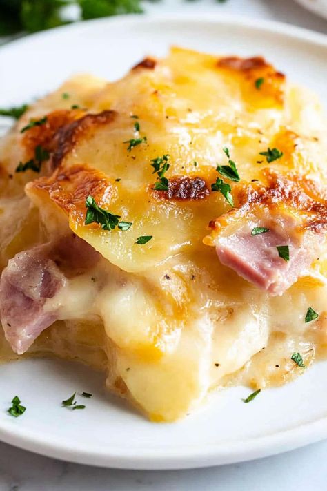 This cheesy scalloped potatoes and ham is absolutely to die for! Serve it as a creamy main course or decadent side dish to meats. Country Ham And Potatoes, Scalloped Potatoes And Ham Pioneer Woman, Ham And Cheesy Scalloped Potatoes, Scallop Potatoes And Ham Oven, Freezer Scalloped Potatoes And Ham, Easy Ham And Scalloped Potato Casserole, Joanna Gaines Side Dishes, Creamy Scalloped Potatoes And Ham, Healthy Scalloped Potatoes And Ham