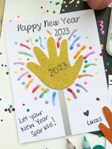 New Year Art Projects For Toddlers, New Year New Me Crafts For Kids, New Years Hand Print Crafts, Handprint New Years Crafts, New Years Eve Arts And Crafts For Kids, Happy New Year 2024 Activities For Kids, New Year’s Art For Kids, Calendar Handprint Ideas, New Years Daycare Craft