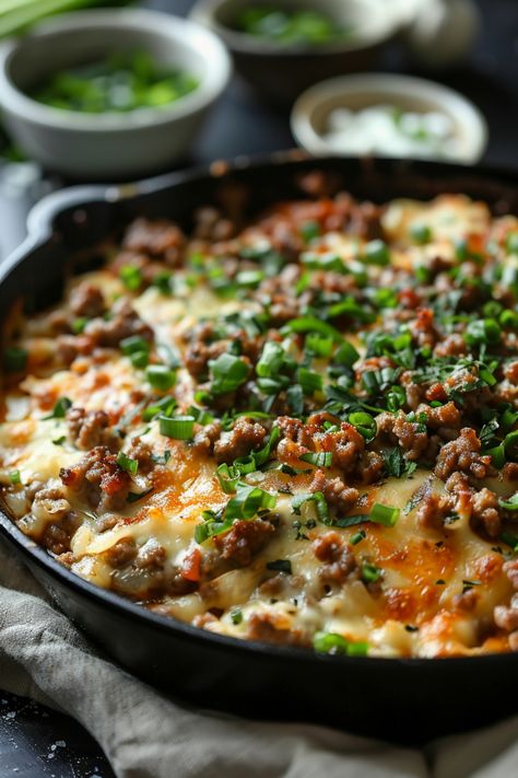 Cheesy skillet dish topped with ground meat, green onions, and herbs. Ground Beef Quick Recipes, Beef Quick Dinner Recipes, Beef Cast Iron Recipes, Ground Beef Recipe Low Carb, Quick Hearty Meals, Ground Meat Skillet Recipes, Ground Beef And Pierogies, Cast Iron Skillet Pasta Recipes, Last Minute Ground Beef Dinners