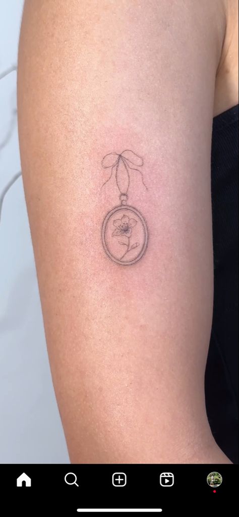 Hand Bell Tattoo, Dainty Sticker Tattoos, Tiny Tattoo Arm Sleeve, March Birth Tattoo Ideas, Tiny Mirror Tattoo, Dainty Tattoos For Lost Loved Ones, Dainty Tattoo Ideas For Women, Oval Locket Tattoo, Locket Tattoos Simple