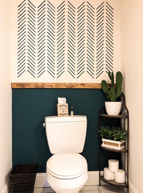 Gave this boring builder grade bathroom some life! Used herringbone stencil to get the beautiful texture at the top of the wall. Separated the pattern from the solid wall with early American stained pine. Bathroom Half Painted Wall, Bathroom Paint Pattern Ideas, Subtle Eclectic Decor, Three Tone Walls, Bathroom Toilet Accent Wall, Wall Redo Ideas, Plain Wall Makeover, Small Bathroom Wall Paint Ideas, Accent Wall For Small Bathroom