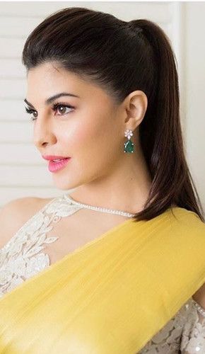 Jacqueline with a simple and chic high ponytail hairstyle that is perfect for medium wavy hair. a small and tiny high puff near the crown of her head adds to the overall charm of her look. Saree With Ponytail, Ponytail For Saree Look, Ponytail Hairstyle On Saree, Ponytail On Saree, Simple Puff Hairstyle, Saree Simple Hairstyles, Ponytail Hairstyles For Saree, Straight Hair Ponytail Ideas, Hair Puff Styles