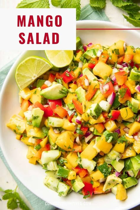 This mango salad is bursting with juicy mango chunks, along with avocado, red peppers, cucumbers and fresh herbs in a tangy lime dressing. Delicious as a side dish, or serve it over greens for a refreshing main dish! Mango Avocado Salad Recipe, Chickpea Mango Salad, Mango Salads, Avocado Mango Salad Recipes, Chop Salads, Salad With Mango And Avocado, Mango Avacado Salad, Mango Cucumber Salsa Recipe, Mango Avacoda Salad