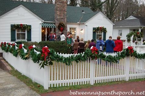 Christmas Decorating Ideas for Porches, Doors and Windows Christmas Garland Fence Ideas, White Picket Fence Christmas Decor, Christmas Lights Fence Ideas, Christmas Garland Outdoor Fence, Picket Fence Christmas Ideas, How To Decorate A Fence For Christmas, Garland On Fence Christmas, Decorating A Fence For Christmas, Decorate Fence For Christmas