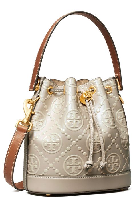 Contrast stitching accentuates the signature embossed leather and structured silhouette of this refined bucket bag accented with Tory Burch hardware. Lined Leather Imported Bucket Bags For Women, Tory Burch Bucket Bag, Luxury Diaper Bag, Classy Bags, Fall Bags Handbags, T Monogram, Tory Burch Purse, Watches Collection, Designer Leather Handbags