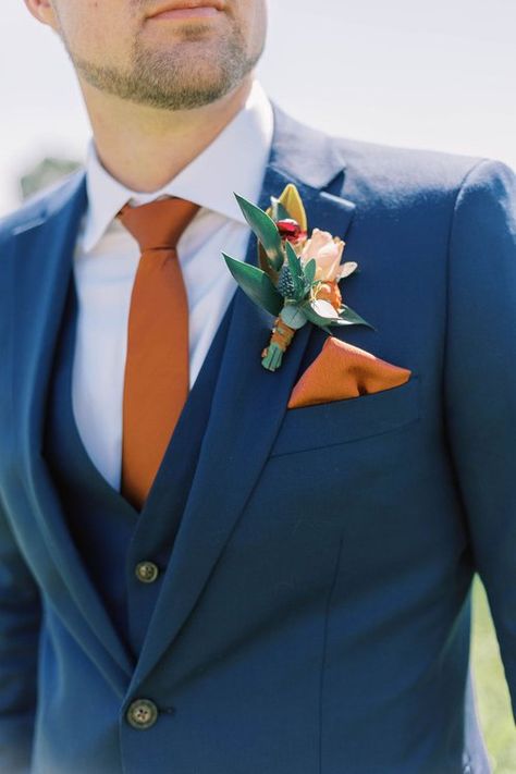 Blues And Orange Wedding, Navy Blue Suit Rust Tie, November Wedding Groom Attire, Blue Suit With Orange Tie, Blue Suit Terracotta Tie, Orange Ring Bearer Outfit, Navy Blue And Burnt Orange Wedding Suit, Navy Blue Suit With Burnt Orange Tie, Navy Blue Tuxedo Wedding Burnt Orange