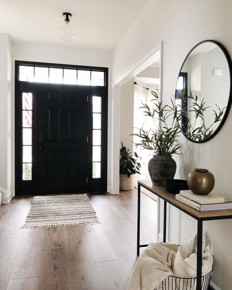 Black Entry Way Door Inside, Black And White Home With Wood Accents, Black White And Wood Hallway, Black Interior Front Door With Transom, Front Entry Door Black, Entryway Black Mirror, Foyer Black Door, Black Accent Entryway, White Black Wood Decor