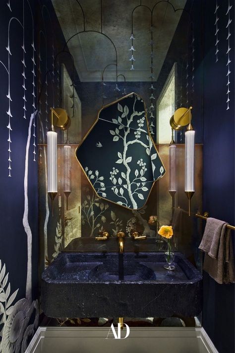 In a powder room of actor and entrepreneur Gwyneth Paltrow's home, hand-painted wallpaper and a mirror by MJ Atelier, sconces by Giopato & Coombes through StudioTwentySeven, and an antique marble sink from Stone Objects with THG fixtures all given the smaller space a moodier and regal feel. #bathroom #powderroom #sink #sconces #sink #faucets #bathroommirror #vanity #wallpaper #towels #mirroredwall #moodystyle #decor #lightingfixtures #towelholder #flowers #art #painting #bathroomwallpaper Colin King, John Baldessari, Roman And Williams, Scenic Wallpaper, Hand Painted Wallpaper, Shower Fixtures, Up House, New York Apartment, Green Tile