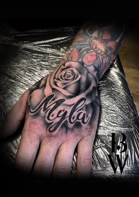 Rose hand tattoo. Men's tattoo. Child's name. By Beth wilde @ Wilde Ink, Wakefield. Cover Up Name Tattoos, Tattoos For Childrens Names, Hand Tattoos Pictures, Tato Nama, Name Tattoo On Hand, Rose Tattoo With Name, Herren Hand Tattoos, Small Wave Tattoo, Names Tattoos For Men