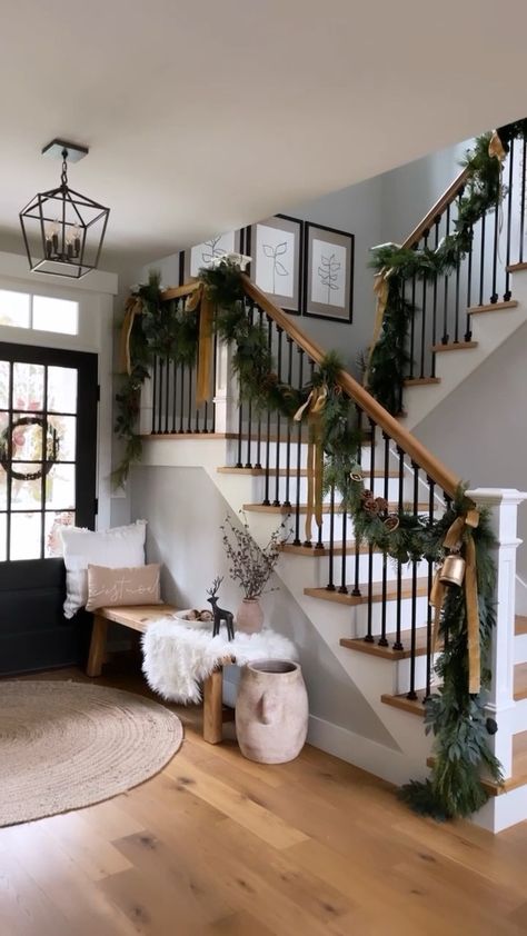 Townhouse Holiday Decor, Eucalyptus Garland Staircase, Stair Railing Holiday Decor, Wreaths On Stair Railing, White Christmas Staircase Decor, Garland Stair Railing, Christmas Decor Ideas Stair Railing, Stair Rail Garland Christmas Decor, Stairwell Garland Christmas