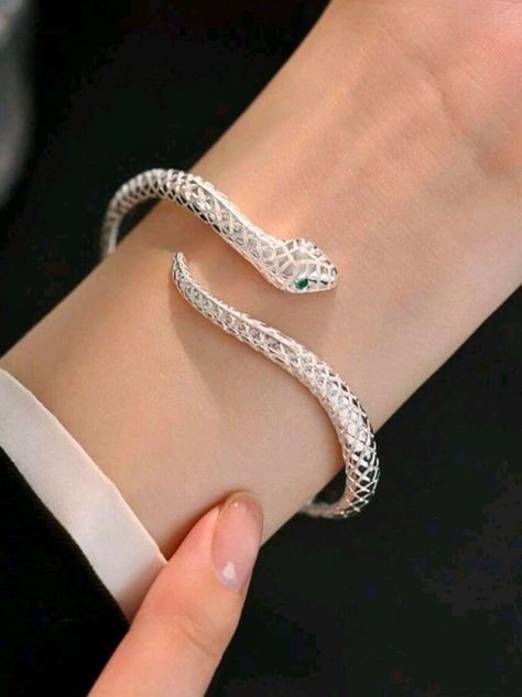 Unleash your inner serpent with this Adjustable Silver Snake Bangle! Featuring a sleek, coiled design that wraps gracefully around your wrist, this bangle symbolizes transformation and power. Its adjustable fit ensures it slips comfortably onto any wrist, making it a versatile accessory for any outfit or occasion. Whether you're drawn to its bold, edgy look or its deeper symbolism of rebirth and resilience, this snake bangle is a statement piece that commands attention. Embrace your unique style and let this serpent be a stylish reminder of your strength and evolution. Make it yours today! Ouroboros Bracelet, Ouroboros Jewelry, Cool Bracelets, Chunky Silver Bracelet, Gifts For Young Women, Silver Snake Bracelet, Snake Bangle, Bracelet Trendy, Popular Bracelets