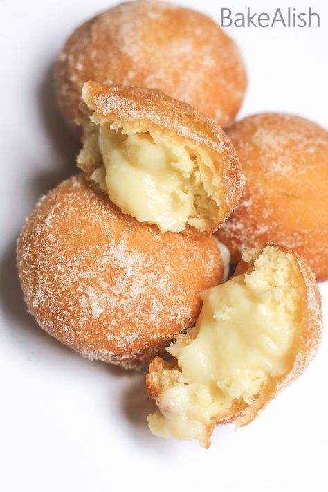 These Vanilla Custard Filled Donuts are also called Bomboloni. A soft and fluffy doughnut recipe with pastry cream filling on the inside Custard Filled Donuts Recipe, Maple Cream Filled Doughnut, Soft Custard Rolls, Cream For Donut Filling, Lemon Filled Donuts Recipe, Bakery Doughnut Recipe, Custard Doughnut Recipe, Filling For Donuts Recipes For, Angel Cream Donut Filling