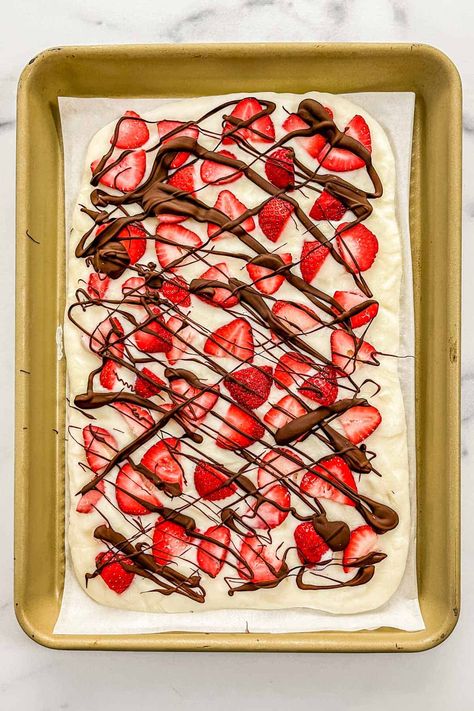 Strawberry chocolate frozen yogurt bark on a parchment lined sheet pan. Frozen Yogurt Bark Healthy, Yogurt Bark Healthy, Strawberry Yogurt Bark Recipe, Chocolate Yogurt Bark, Bark Healthy, Protein Bark, Strawberry Yogurt Bark, Protein Sweets, Yogurt Bark Recipe