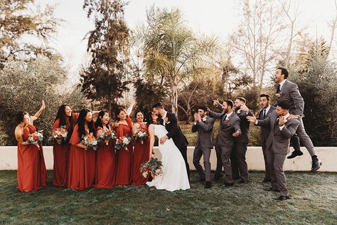 Grey And Rust Wedding Party, Fall Wedding Grey Suits, Tan Groomsmen Suits With Terracotta, Dark Grey And Terracotta Wedding, Terracotta And Grey Wedding Party, Copper Bridesmaid Dresses With Groomsmen, Cinnamon Wedding Color Scheme Groomsmen, Groom And Groomsmen Attire Fall Wedding, Grey And Orange Suit