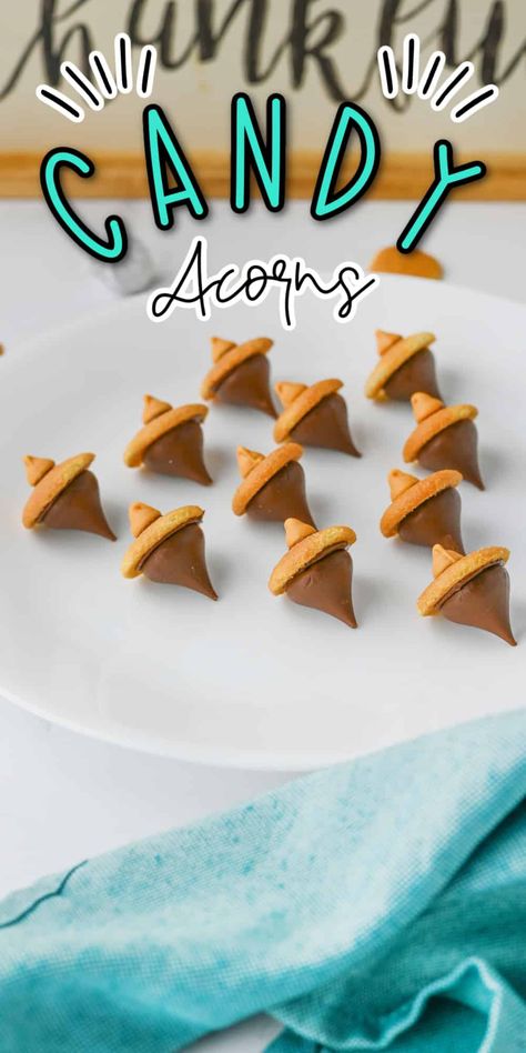 Candy Acorns are a delightful and simple treat that’s perfect for fall! Made with chocolate kisses, mini cookies, and a touch of chocolate, these bite-sized snacks resemble adorable acorns. They’re easy to make, fun to share, and add a sweet touch to any autumn gathering or Thanksgiving table. Candy Acorns Hershey's Kisses, Thanksgiving Snack For Kids To Make, Acorn Candy Kisses, Fall Candy Treats, Turkey Candy Treats, Thanksgiving Sweet Treats For Kids, Thanksgiving Candy Treats, Hershey Kiss Acorns, Candy Acorns