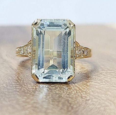 This vintage ring is a stunning piece of fine jewelry, perfect for special occasions such as engagement, wedding, anniversary, birthday, Valentine's Day, Christmas, or Mother's Day. Gorgeous Vintage 14k yellow gold natural blue aquamarine in a rectangular shape  center weight 5.52ct. size 13.8x8.7mm very nice light sky blue color  nice luster, very lively, and nice cut. Eye Clean aquamarine Brilliant, sparkly. side  round cut diamonds total weight 0.08ct ring size 5 Resizable  Appraisal availabl Aquamarine Engagement Ring Art Deco, Aquamarine Emerald Cut Ring, Expensive Engagement Rings Unique, Engagement Rings Light Blue, Vintage Aquamarine Engagement Ring, Aquamarine And Diamond Ring, Light Blue Engagement Ring, Light Blue Ring, Antique Aquamarine Ring