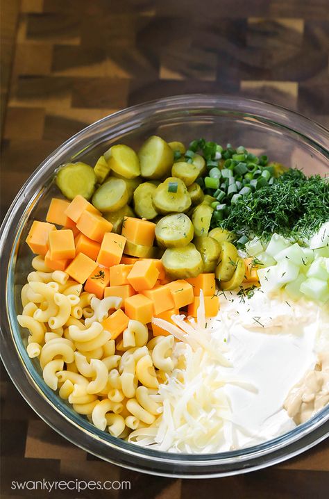 Pickle salad ingredients in a mixing bowl. Sour cream, mayo, sliced dill pickles, cucumbers, mustard, diced sharp cheddar cheese, cold pasta, and green onions. Traditional Pasta Salad, Summer Macaroni Salad, Pickles Cucumbers, Pickle Salad, Pickle Pasta Salad, Pickle Pasta, Current Recipes, Macaroni Salads, Dill Pickle Pasta Salad