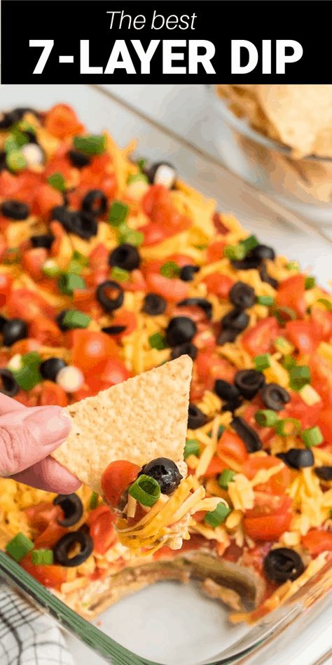 This 7-Layer Dip is perfect for parties, tailgates, or just a fun night of snacking at home. With seven layers of cheese, refried beans, black olives, green onions, and more, you're going to love the flavor and taste of each and every dip. Moms Seven Layer Dip, Taco Dip Tray, Seven Layer Taco Dip Refried Beans, Mexican Layered Dip Recipes, Party Ourderves, Layered Refried Bean Dip, 7 Layer Dip Mexican, Taco Dip With Refried Beans, Mexican Layer Dip Recipe