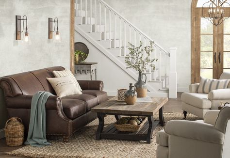 The classic dark brown leather sofa has served as a stereotypical focal point in the living room for decades. If not properly designed and utilized, l... | White And Sage Green  #DarkBrownLeatherSofa #DarkBrownLeatherSofaDecorating #LeatherSofa #BrownLeatherSofa Dark Brown Sofa Living Room, Brown Leather Sofa Decor, Dark Leather Couches, Leather Sofa Decor, Brown Leather Sofa Living Room, Dark Brown Leather Sofa, Leather Couch Living Room Decor, Brown Leather Couch Living Room, Brown Leather Furniture