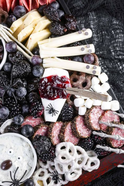 Halloween charcuterie board with bloody brie cheese and mozzarella ghosts. Mozzarella Ghosts, Halloween Themed Desserts, Halloween Charcuterie Board, Yogurt Pretzels, Chocolate Spiders, Halloween Charcuterie, Chocolate Covered Raisins, Club Crackers, Cherry Preserves