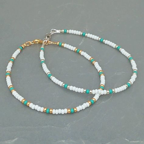 This white turquoise seed bead anklet has been lovingly made using 3mm white and turquoise Preciosa seed beads.  With 3mm Miyuki highlighting beads in either silver or gold. Threaded on strong stainless steel 7 strand Tiger Tail wire and finished with silver/gold plated wire guardians and a lobster clasp, making it easy to put on & take off. With an optional 2" Silver/gold plated extender chain so you can wear the anklet to sit where you feel most comfortable. Matching necklace and or Bracelet a Cute Handmade Bracelets Beads, Cute Necklace Ideas Beads, Cute Beach Necklaces, White And Gold Beaded Bracelet, Anklet Bead Ideas, Diy Seed Bead Bracelet Ideas, Seed Bead Anklet Ideas, Sea Bead Bracelets Ideas, Bead Anklet Ideas