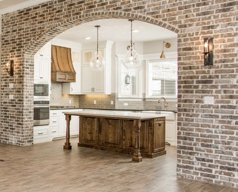 Arched brick wall between LR and kitchen Wide Oak Flooring, Archways In Homes, Vaulted Ceiling Ideas, Brick Archway, Brick Accent Wall, Dreams To Reality, Brick Arch, Brick Kitchen, College Station