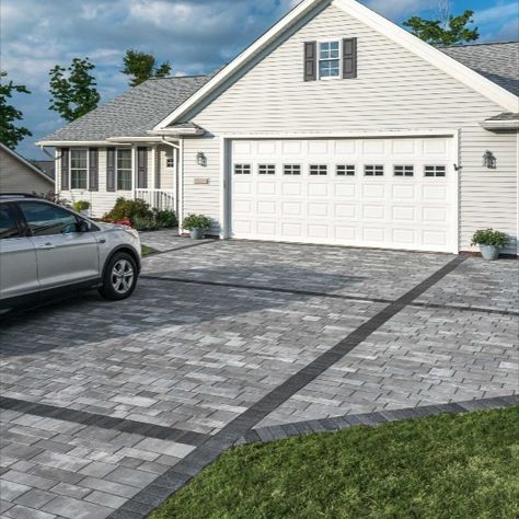 The owners of this property needed a parking solution that wouldn’t impede access to their garage. Unlike a large expanse of asphalt or concrete, which would have visually overwhelmed this modest home, a unique design utilizing Artline proved to be the perfect fit. Geometric bands in a contrasting color were created using Series in Black Granite, to add visual interest and define the driveway from the adjacent parking pad and front walkway. #Driveway #Entrance #Contemporary #Artline #Series Driveway Extension Parking, Driveway Patio Combo, Parking Pad In Front Of House, Parking Pad Ideas, Driveway Layout, Driveway Expansion, Modern Pavers, Driveway Extension, Modern Landscape Design Front Yard