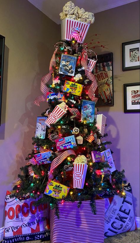 Movie Theatre Christmas Tree, Junky Christmas Trees, Creative Christmas Trees Ideas, Nice Christmas Trees, Crazy Christmas Tree Ideas, Office Christmas Tree Themes, Christmas Tree Ideas Characters, Starbucks Christmas Tree Ideas, Movie Theater Christmas Tree