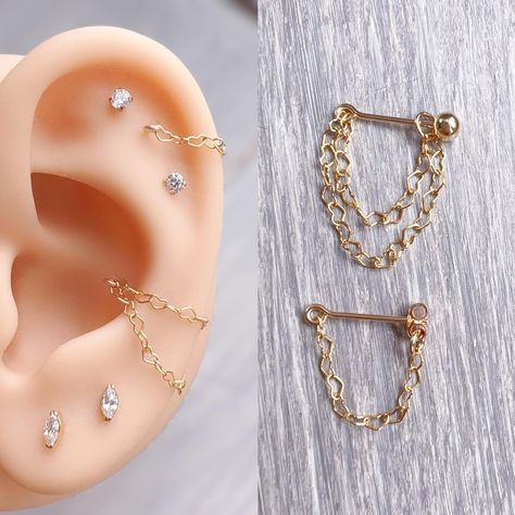 ♥Simply♥Dainty♥Everyday♥Minimal♥ 14k gold filled heart chain earring single or double chains Butterfly back Post length: 11mm 22gauge /0.64mm Screw ball back 3mm Post length: 8mm 22gauge/0.64mm Chain lengths:   Helix single or double chains 25mm 25mm and 32mm  Conch single or double chains 30mm 30mm and 38mm Different post/chain lengths available, please contact me. Earrings are priced individually. Customer advisory note: Due to the size and texture of the ball (back), I would strongly advise w Helix Chain, Unique Ear Piercings, Conch Jewelry, Double Earrings, Cool Piercings, Conch Earring, Double Helix, Cartilage Earring, Dope Jewelry