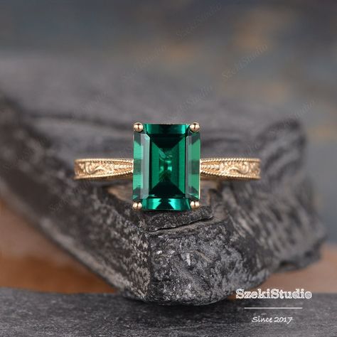 Vintage Emerald Engagement Ring Engraved Delicate Milgrain Band Yellow Gold Elsie Emerald Ring Solitaire Emerald Cut Wedding Ring Filigree ITEM INFORMATION: Metal Type- Solid 14K Rose Gold WIDTH- ( approx. 2.0mm) **Engagement Ring** Center Stone- 7*9mm Emerald Cut Lab Emerald **Stone Replacement** Available with any other gemstones, please feel free to contact me for a quote. **Metal Type** Available in 14K or 18K yellow gold, white gold, and rose gold. Please select from the drop down menu. **P Lab Emerald Engagement Ring, Emerald Engagement Ring Vintage Unique, Emerald Accent Engagement Ring, Real Emerald Engagement Ring, Wedding Ring Emerald Stone, Vintage Emerald Rings Gold, Emerald Engagement Ring Green Unique, Emerald Green Engagement Ring Gold Band, Antique Emerald Ring Vintage