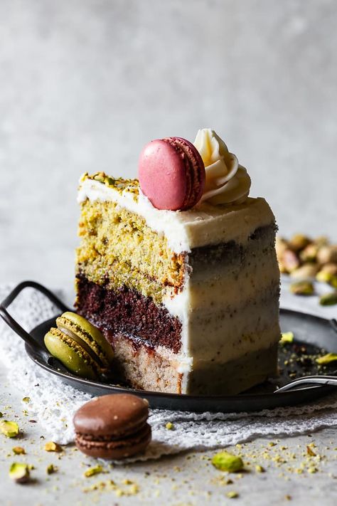 This exquisite Italian Spumoni Cake showcases a delicious trio of strawberry, chocolate and pistachio layered cake. It is crowned with elegantly swirled buttercream and topped with macaron cookies, creating a visibly stunning dessert. Bake Off Cakes Ideas, Fancy Italian Desserts, Tiramisu Layer Cake Recipe, Italian Plated Desserts, Crazy Cake Flavors, Italian Fruit Cake, Gourmet Birthday Cake, Pistachio Almond Cake, Italy Wedding Cake