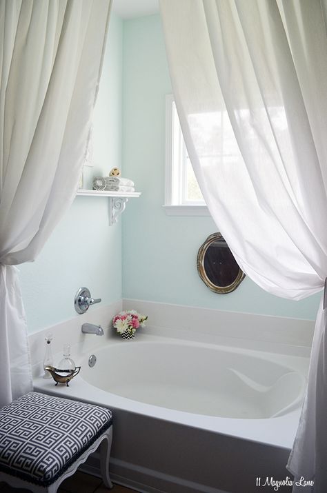 beautiful bath! i love the little things sitting out (flowers, the glass holders + the white curtains really soften it and the old gold mirror ads a bit of chic to it :) also like the aqua colored walls. Tub Ideas, Spa Like Bathroom, Garden Tub, Room Shelves, Trendy Bathroom, Bathroom Spa, White Rooms, Grey Bathrooms, Bath Room