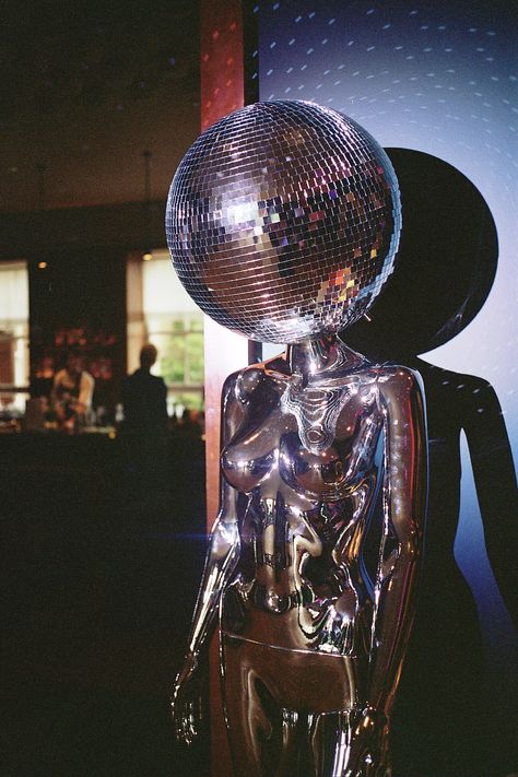 A mirror ball head Disco mannequin prop at a wedding reception room Disco Ball Mannequin, Disco Ball Hallway, Disco Party Inspiration, Disco Party Props, Disco Ball Sculpture, Dark Disco Aesthetic, Modern Disco Aesthetic, Disco Mannequin, Disco Architecture