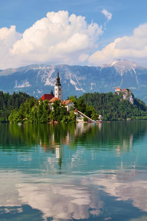 Sweeping alpine panoramas, medieval castles, delectable cakes and desserts, can all be yours to enjoy on a vacation in beautiful Lake Bled, Slovenia. Visitors can hike up to Bled Castle for incredible views, take a leisurely stroll along the lakeshore, or ride a pletna boat out to the island in the middle of the lake. Lake Bled Aesthetic, Santa Maria Church, Bled Castle, Lake Bled Slovenia, Bled Slovenia, Mediterranean Travel, Slovenia Travel, Balkans Travel, Medieval Castles