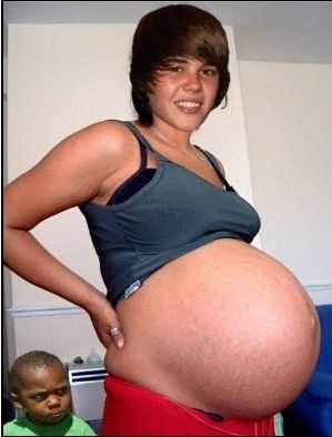 This pregnant Justin Bieber with a small child giving him the side-eye. | The 31 Most Important Pregnant Men Of 2013