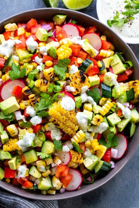 Grilled corn salad drizzled with creamy lime dressing. Fresh ears of corn are roasted on the grill to add a smoky flavor and mixed with colorful vegetables. #corn #grilledcorn #cornsalad Packable Lunches, Cookout Recipes, Jello Salads, Seasoned Corn, Summertime Salads, Grilled Corn Salad, Grilled Roast, How To Cook Corn, July Recipes