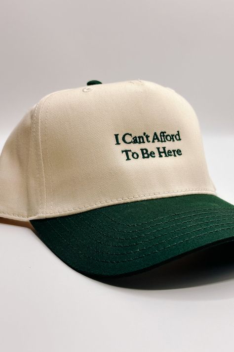 Introducing the I Can't Afford To Be Here" Trucker Hat, a witty and lighthearted accessory for your everyday adventures. This hat features a beige body adorned with bold dark green embroidery that humorously declares "I Can't Afford To Be Here." The dark green bill adds a contrasting touch, while the adjustable back ensures a comfortable fit. On the back of the hat, you'll find the embroidered phrase "The Happiest :)" to add a touch of whimsy. Perfect for those who appreciate humor and want to a Crochet Trucker Hat, Embroidered Hat Ideas, Trucker Hat Style, Embroidered Trucker Hats, The Hood Aesthetic, Trucker Hat Designs Ideas, Trucker Hat Ideas, Dark Green Embroidery, Funny Baseball Hat