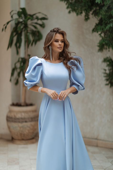 Embrace the magic of sky-blue with our Sky-Blue Backless Puff-Sleeve Midi Dress. The mesmerizing color evokes a sense of tranquility and beauty, while the backless design adds a daring and sultry touch. #mididress #skybluedress #bluedress #dress #dresses #womenwear #stylish #chic #backless #elegant #dressup #dresslover #weddingdress #eveningdress Woman Dress Midi, Blue Bridesmaid Dresses Sleeves, Puff Sleeve Dress Formal, Elegant Modest Dresses, Blue Classy Dress, Sky Blue Dresses, Blue Dress Aesthetic, Mode Batik, Sky Blue Outfit