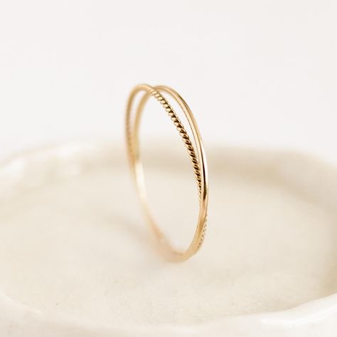 Two intertwined gold rings: a delicate braided band with a simple round-profile band. Double the fun! Braided Gold Wedding Band, Him And Her Rings, Simple Promise Rings Gold, Small Gold Rings Simple, Simple Promise Rings For Her Gold, Simple Everyday Jewelry, Small Gold Rings, Simple Gold Rings Everyday, Everyday Ring Stack